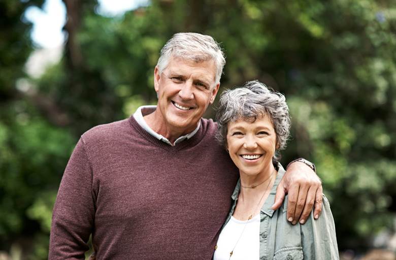 smiling senior couple with dental implants in Toronto