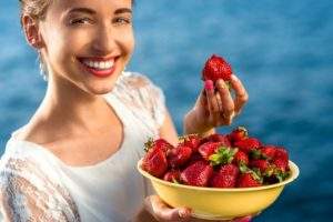 Woman eating strawberries