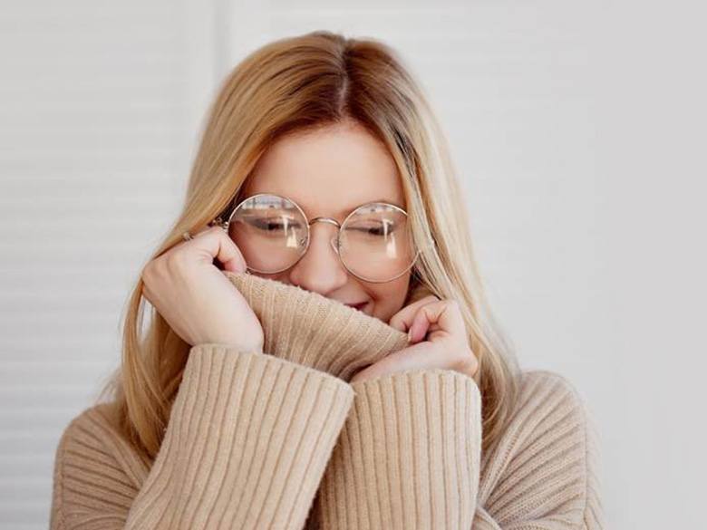 a woman hiding her smile needing teeth whitening in Toronto