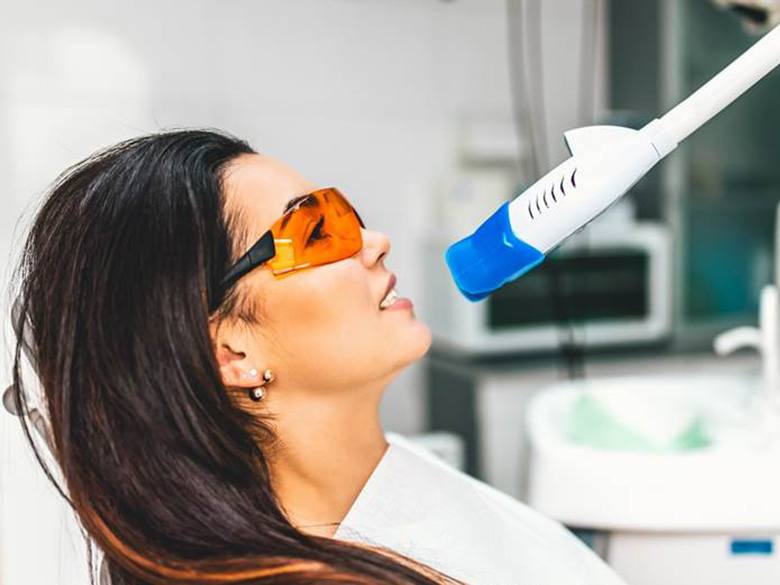 a patient undergoing teeth whitening in Toronto