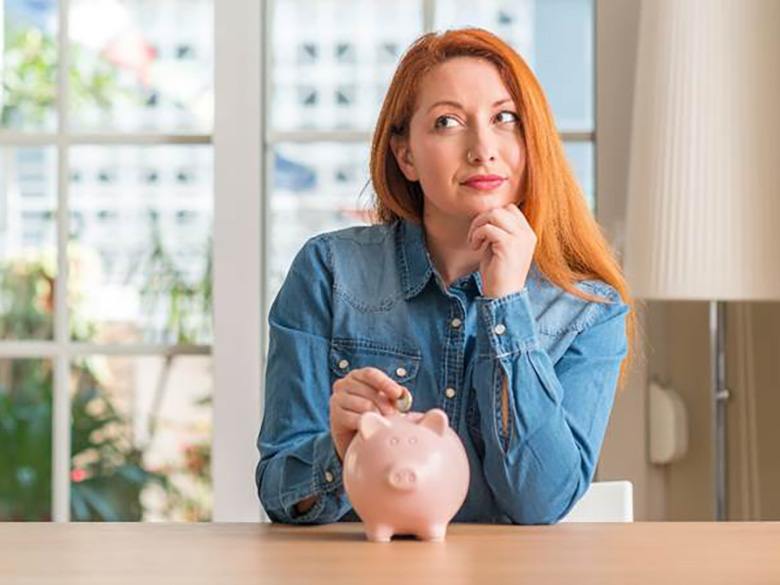 a woman thinking about paying for teeth whitening in Toronto