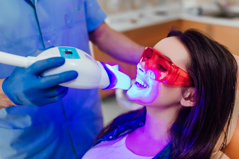 person with stained teeth having them whitened by dentist